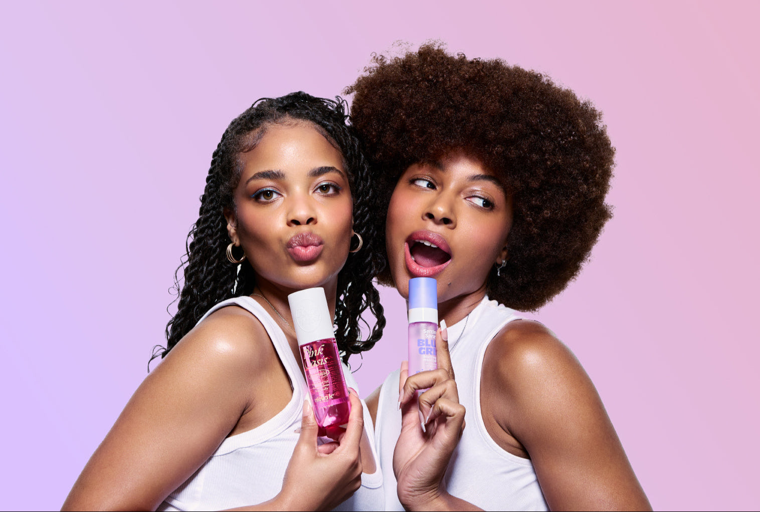 Two women holding skincare products against a pink background